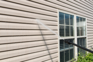 Power washing home exterior.